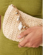 straw shoulder bag with ball and chain handle with faux shell charms