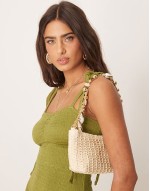 straw shoulder bag with ball and chain handle with faux shell charms