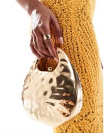 hammered top handle clutch bag in gold